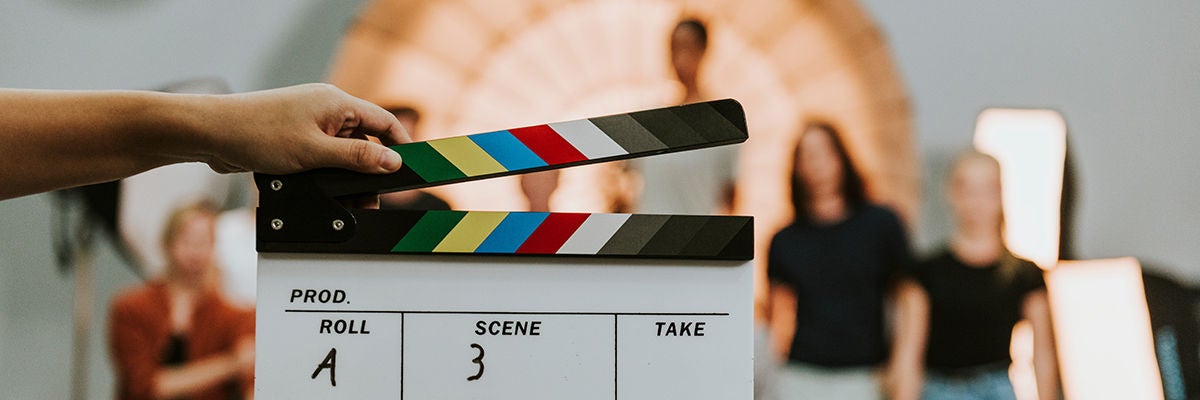 Woman holding a movie production clapperboard