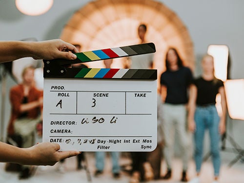 Woman holding a movie production clapperboard